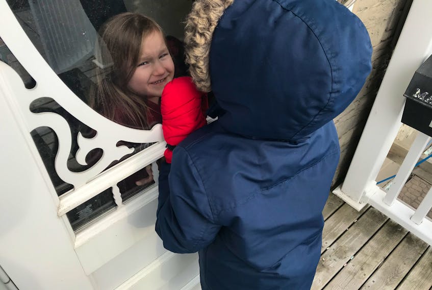 Four-year-old Amarah Ashleigh Gallant of Whitney Pier visited with her cousin Aaiden through the closed glass door of her home, during one of Aaiden's walks with his mother earlier this month. Amarah and Aaiden were born exactly four months apart and are usually inseparable. The children are in the pre-primary class at Harbourside Elementary School and usually played together daily. As a result of the COVID-19 restrictions, their parents are now allowing short visits through a closed glass door. CONTRIBUTED