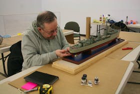 Jim Myles, well-known Burin Peninsula artist, is also volunteering his time and talents to the model ship exhibition. He was getting the HMS Tartar ready for display on Wednesday, Feb. 19. PAUL HERRIDGE/THE SOUTHERN GAZETTE