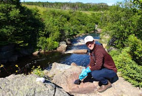 A little bit of water and a barbecue brush was all Matt Janes, a volunteer with MUN Hope, had to use to get the graffiti off the rocks. – Andrew Waterman/The Telegram