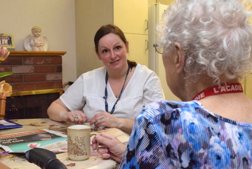<p>Betty Perrin talks with VON Colchester East Hants continuing care assistant Vanessa Campbell during a morning home care visit. Perrin has three home visits each day through the VON, all helping with daily tasks and meal preparation.</p>
