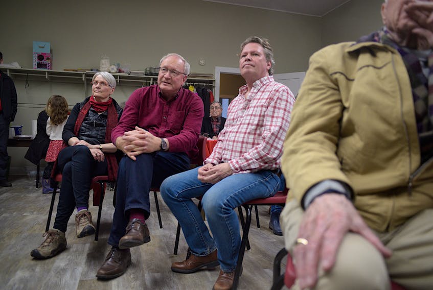 P.E.I. Liberal Leader Wade MacLauchlan, centre, and his partner Duncan McIntosh watch election results roll in at Stanhope Place on Tuesday, April 23. - Nathan Rochford
