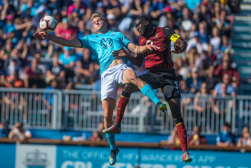 HFX Wanderers FC striker Tomasz Skublak, left, and Valour FC defender Skylar Thomas vie for the ball during a game at the Wanderers Grounds in Halifax last season. (FILE)