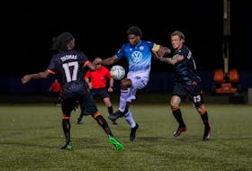HFX Wanderers FC midfielder Andre Rampersad tries to control the ball as two Forge FC defenders pursue during an Aug. 19 CPL game in Charlottetown. (Canadian Premier League)

