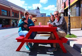 Jackie Hesson sat down for a coffee with family after a stroll from Churchill Square. She would like to see the City of St. John’s continue with the pedestrian mall past the scheduled closing date of September 7. Left to right: Jackie Hesson with dog Marley, Julia Willis with dog Cooper, Karen Willis and Keith Stapleton.  – Andrew Waterman/The Telegram