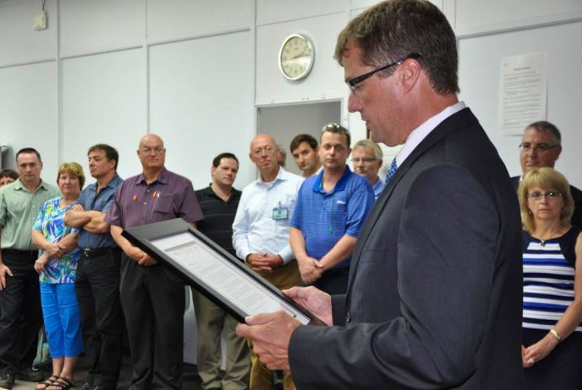 <p>Stuart MacLean, CEO of the Workers’ Compensation Board of Nova Scotia, reads a letter recognizing CKF as a leader in workplace safety.&nbsp;</p>