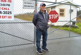 Claude Peach of Long Beach Road in Port Morien, stands at the gates to the idle Kameron Collieries owned Donkin Mine. CAPE BRETON POST