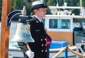 Leading Seaman Deanna Morton of HMCS Queen Charlotte rings a bell for each Canadian navy ship lost during the Battle of the Atlantic. The annual commemoration ceremony, held the first Sunday of May, was conducted at the wharf in North Rustico this year. Guardian photo by Nigel Armstrong
