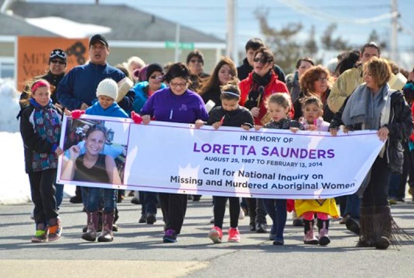 More than 100 people march in a vigil in memory of murder victim Loretta Saunders during an event at the Membertou Trade and Convention Centre Sept. 24, 2017.