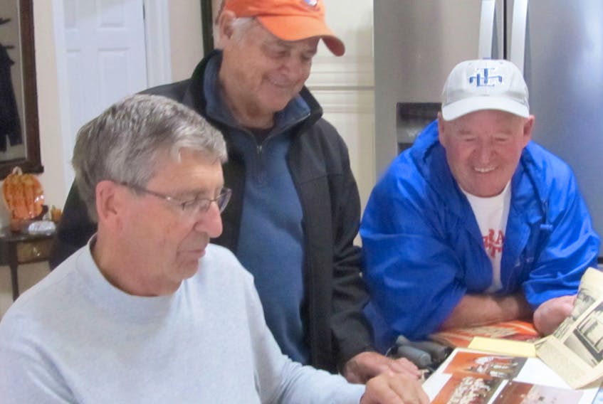 Keith Mackenzie, left, Bob Crowell and Barry Clark enjoy researching some local sports history.