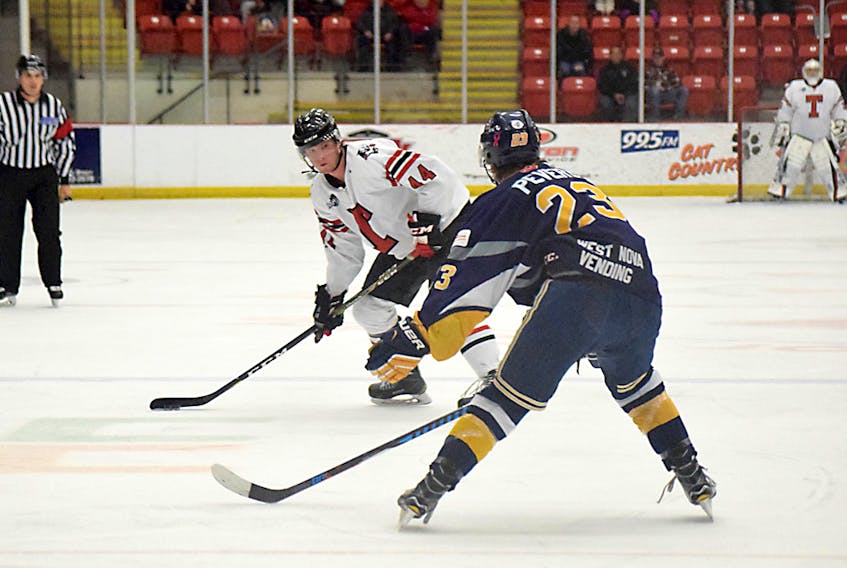 Jack McGovern of the Truro Bearcats looks to get a shot through while Conor Peveril of the Yarmouth Mariners challenges during regular season action. The teams renew acquaintances in a MHL first-round playoff series, which gets started Thursday in Yarmouth.