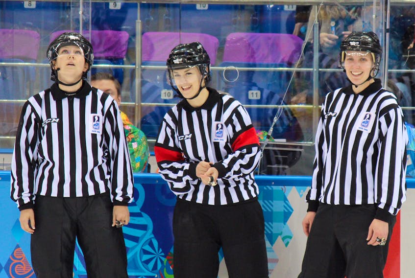 Denise Caughey-Sondjo, right, officiated women's hockey at the Sochi Olympics.