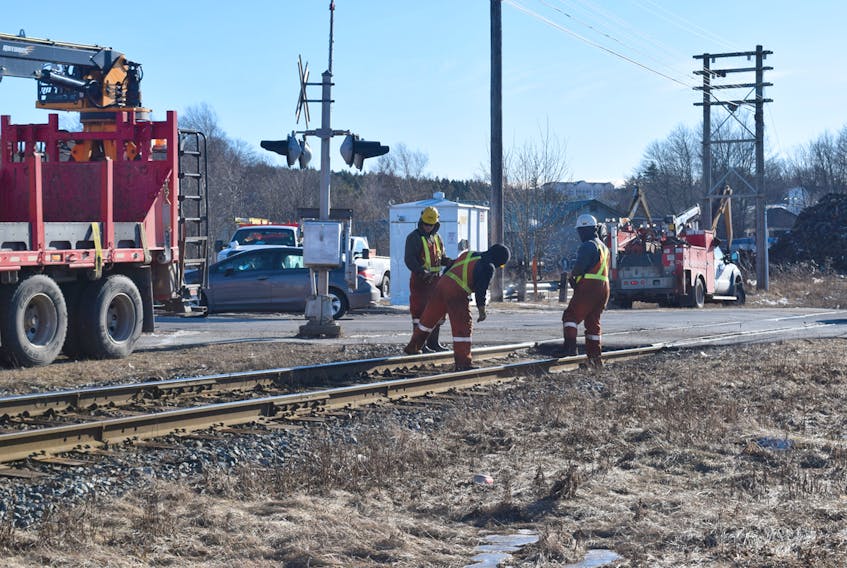 CN workers repair a broken rail line on East Prince Street.