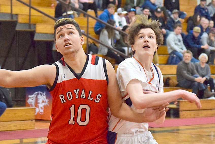 Sam Hyde, right, of the Cobequid Cougars battles for a rebound against Danzel MacDonald of the Riverview Royals during action at the recent CEC Snowball basketball tournament in Truro.