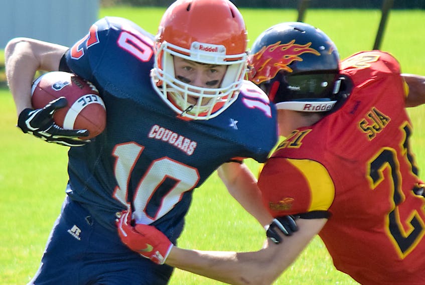 Receiver Nick Lemon fights off a tackle during action last week during the CEC Cougars’ home opener in the Nova Scotia School Athletic Federation Football League. The Cougars dropped a close game to the Sir John A Macdonald Flames, 19-15. Joey Smith/Truro News