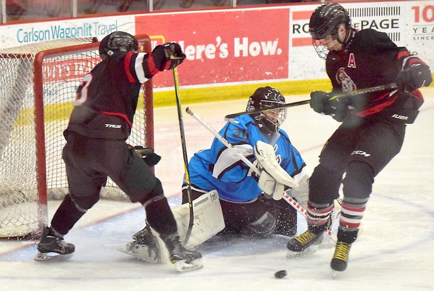 Burke Murray, right, of the Pictou County Crushers, goes hard to the net in search of a rebound during the HNS Day of Champions midget A division final.
