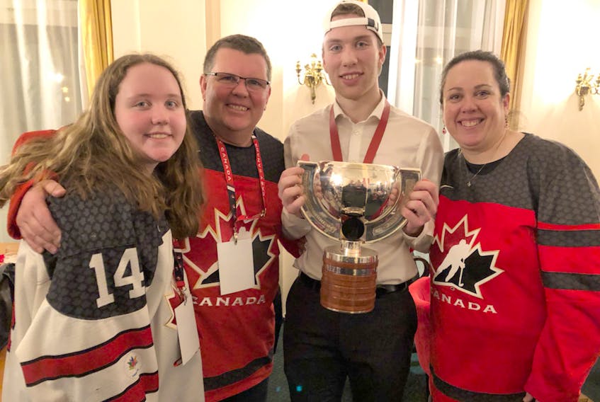 Gold medal happiness! Jordan, left, Jamie, Jared and Sandra McIsaac enjoy the moment following Canada’s world junior hockey victory.