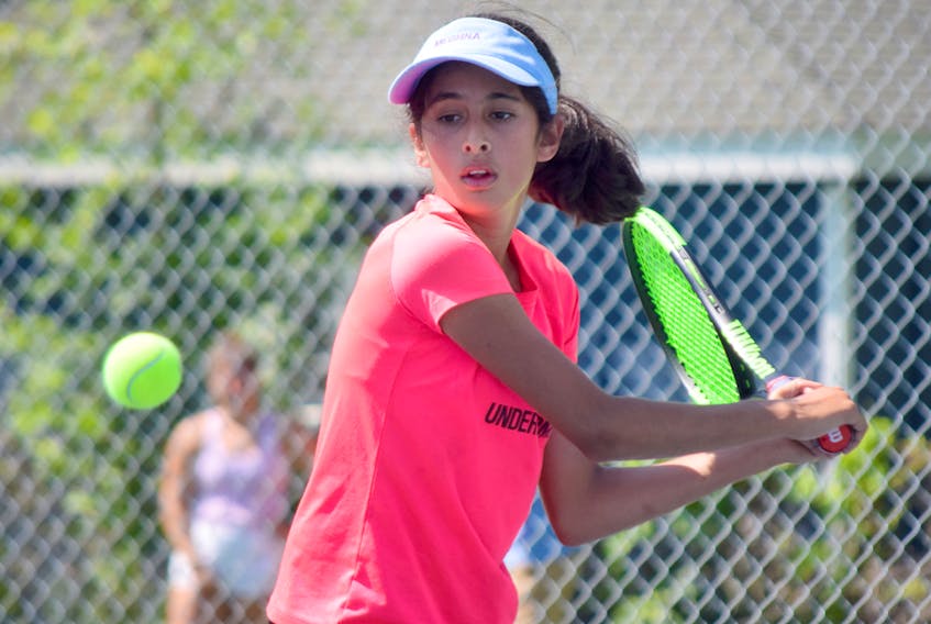 Meghna Anand of the Truro Tennis Club returns this ball during U12 girls singles action on Thursday.