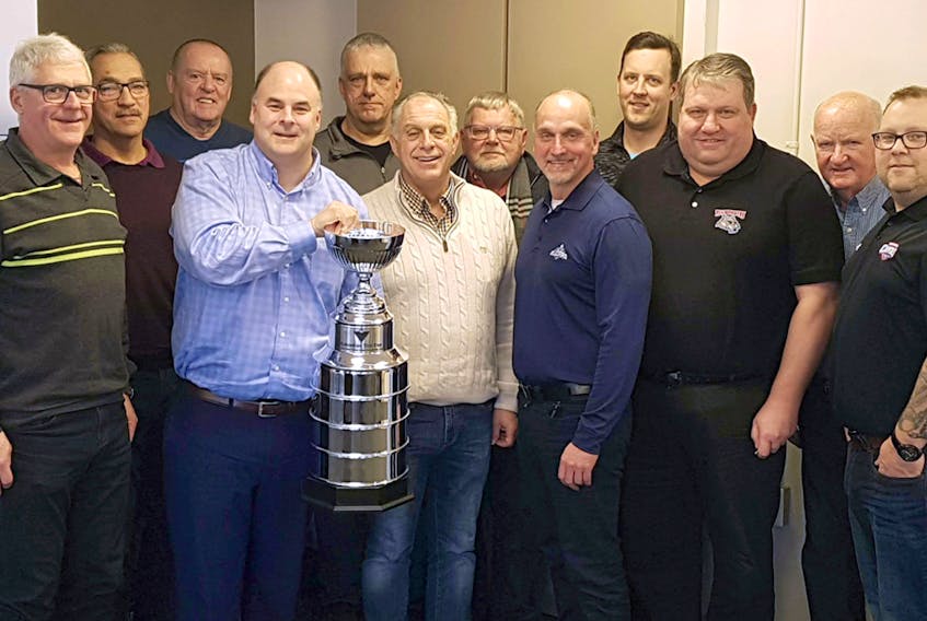 Maritime Junior Hockey League interim president Dave Ritcey holds the Canadian Tire Cup, surrounded by the MHL board of governors at a recent meeting in Amherst.