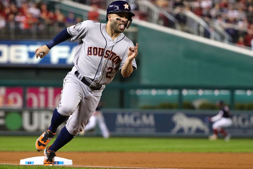 Jose Altuve #27 of the Houston Astros rounds third base and scores a run on a hit by Alex Bregman against the Washington Nationals during the first inning in Game Four of the 2019 World Series at Nationals Park on October 26, 2019 in Washington, DC.