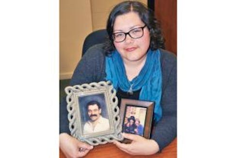 ['Sara MacKay, who lives in New Glasgow, holds a photo of her father, Mike, and one of her Uncle Tom with Mike – one of the 26 miners killed when the Westray mine exploded.']