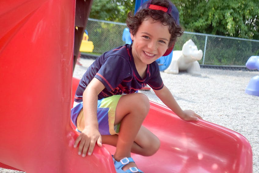 Lucas Bonilla-Smith didn’t have the splash pad to beat the heat at Columbus Park on Monday, but he still had fun playing on the slide and other playground equipment.