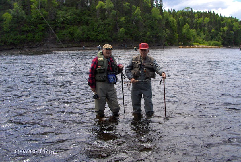 Ches Loughlin, right, and Ralph Hiscock are seen fishing together in Deer Lake Hole on the Humber River in 2015. Mr. Loughlin died in Corner Brook on Saturday. 
Photo by Jeff Wells

