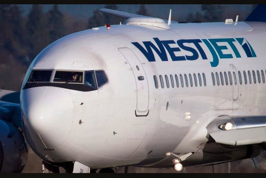 FILE PHOTO: A pilot taxis a Westjet plane to a gate.