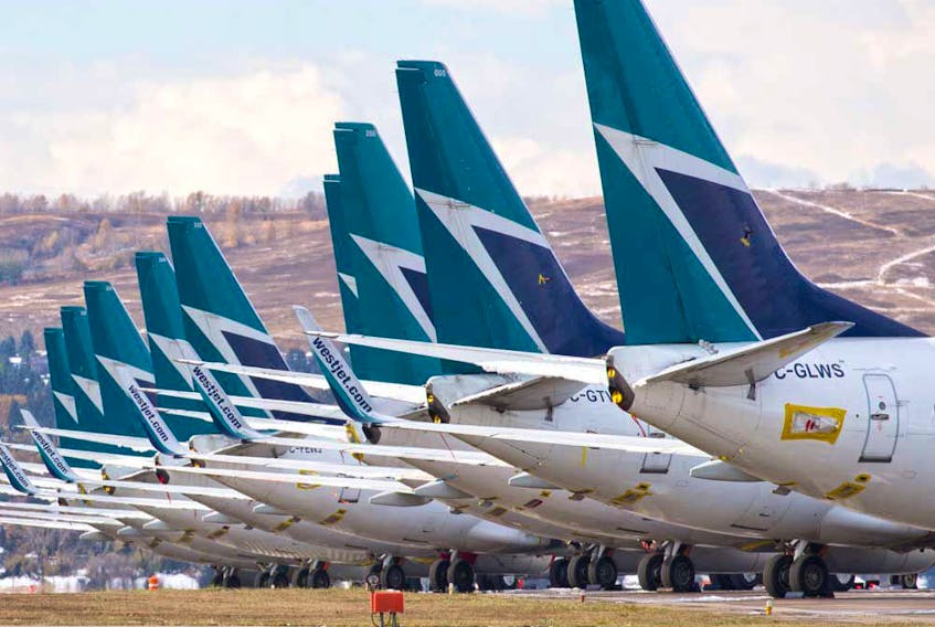 Sidelined WestJet Boeing 737 jets are parked at Calgary International Airport. 
