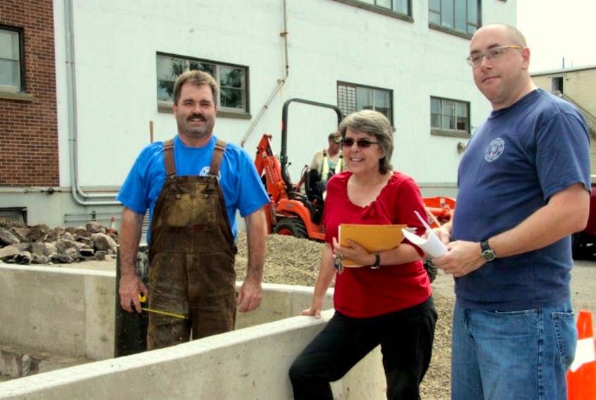 <p>Pictured here are members of the Windsor Fire Department executive (from left: fire chief Scott Burgess, treasurer Crystal Smith, and deputy fire chief Jamie Juteau) at the Fred Fox memorial tribute site earlier this summer while it was still under construction. The unveiling was scheduled for Oct. 4.</p>