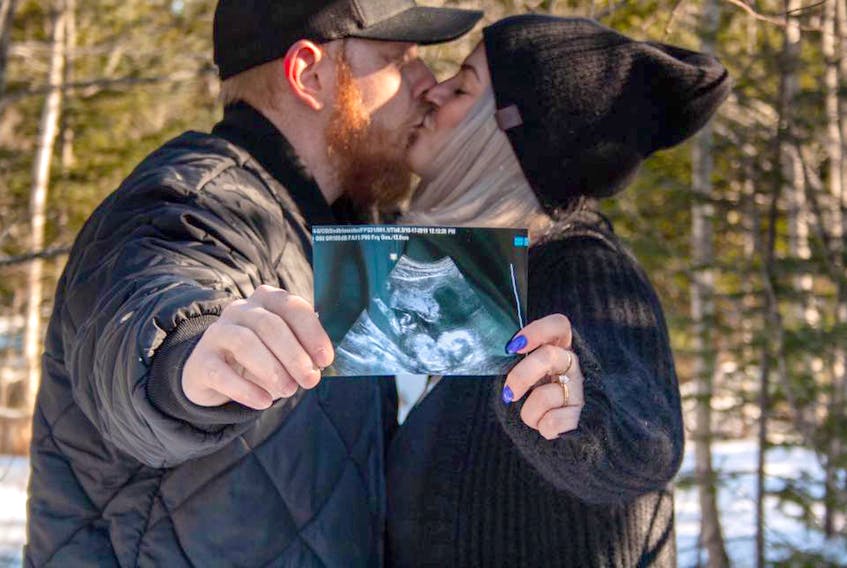 Kayla Beaver and her fiance Cody Conway hold a photo of their unborn baby, captured during an ultrasound, in February 2020. Conway will be the only person allowed to join Beaver during and after her delivery at the IWK Health Centre as visitor restrictions at the hospital have tightened amid the coronavirus pandemic - Courtney Hamilton Photography
