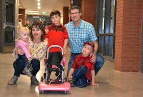 The Ferrish family from Summerside was in Charlottetown Sept. 29 to pick up the customized wheelchair built for two-and-a-half-year-old Ellis by technicians from the School of Sustainable Design Engineering at UPEI. From left are Ellis, Lori, Jonah, Trent and Nolan Ferrish.