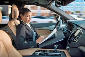 A woman reading inside an autonomous driving Volvo. Volvo/Handout