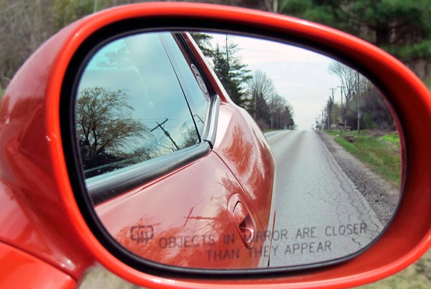 A convex passenger-side mirror with warning. Jil McIntosh/Driving