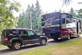 A motorhome with a ‘dinghy-towed' Jeep. RV Lifestyle photo