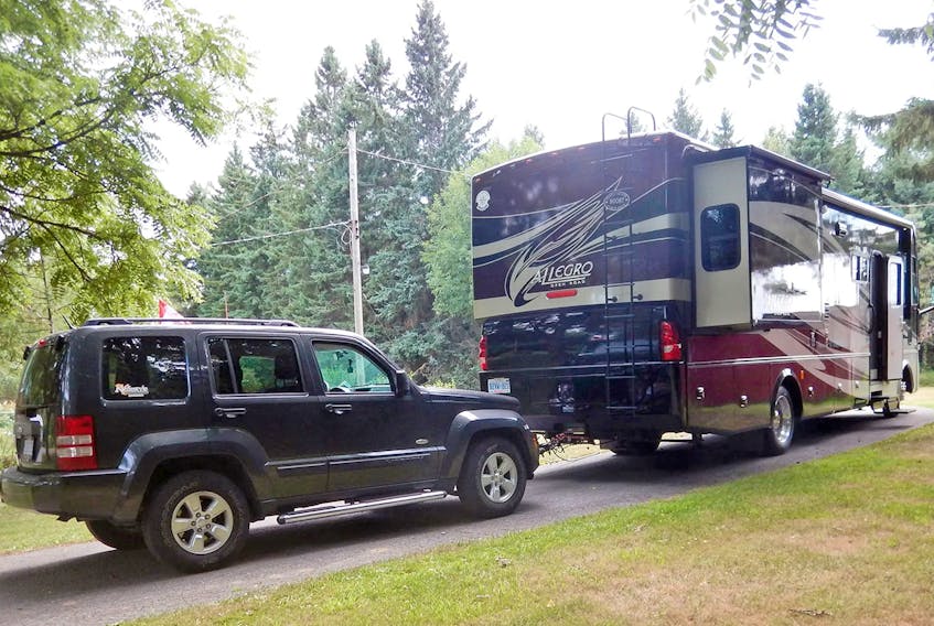 A motorhome with a ‘dinghy-towed' Jeep. RV Lifestyle photo