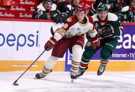 Halifax Mooseheads defenceman Lucas Robinson hooks Bathurst Titan forward Dylan Andrews during a Nov. 20 game at the Scotiabank Centre. (ERIC WYNNE/Chronicle Herald)