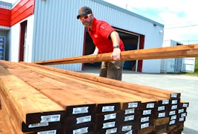 Adam McPherson, yard manager at Wilson’s Home Hardware in New Waterford, moves some of the pressure-treated lumber they currently have left for a customer in Mira who’s building a deck. Store officials say there’s not only a serious shortage of two-by-fours and pressure-treated wood in the province, but all building supply products tied to wood, right down to screw nails. Sharon Montgomery-Dupe/Cape Breton Post

