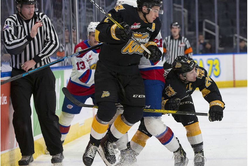 The Edmonton Oil Kings' Jake Neighbours (21) is checked by the Brandon Wheat Kings' Braden Schneider (2) and Connor Gutenberg (24) during third period WHL action at Rogers Place, in Edmonton Tuesday Jan. 28, 2020. The Oil Kings' won 6-2. Photo by David Bloom