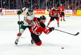 Halifax Mooseheads defenceman Cameron Whynot, left, battles Quebec Remparts forward Nathan Gaucher for the puck during a 2019-20 QMJHL game at the Scotiabank Centre. (CONTRIBUTED/Trevor MacMillan)