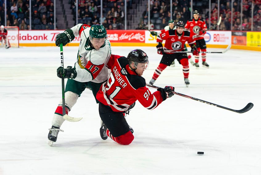 Halifax Mooseheads defenceman Cameron Whynot, left, battles Quebec Remparts forward Nathan Gaucher for the puck during a 2019-20 QMJHL game at the Scotiabank Centre. (CONTRIBUTED/Trevor MacMillan)