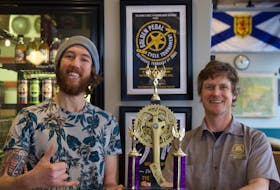 Tony Wood, left, and Cam Hartley with the trophy to be awarded to the winner of the upcoming Golden Pedal Cycling Tournament to be held on Feb. 1 at the Schoolhouse Brewery in Windsor. The proceeds from the tournament will go to support the Windsor Food Bank. CONTRIBUTED