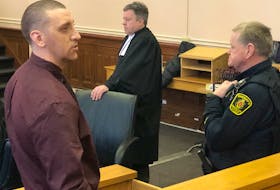 John Squires speaks to a loved one in the gallery during a break in his trial at Newfoundland and Labrador Supreme Court in St. John’s Tuesday afternoon. Squires, Brandon Glasco and Shane Clarke have pleaded not guilty to murder conspiracy. Tara Bradbury/The Telegram