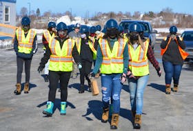 Participants in the Women Unlimited's Career Exploration Program make their way toward the Membertou Place job site for a tour of the work going on at the three-storey, 55,000 square-foot office building currently under construction. DAVID JALA/CAPE BRETON POST