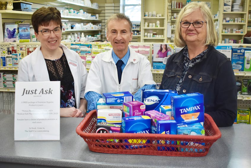 Women in need can now receive free feminine hygiene products at the Medical Hall Pharmasave through a program called Just Ask. From left are pharmacist Laura Rowan, owner Kevin MacKay and program organizer Leslie Morin. ADAM MACINNIS/THE NEWS

