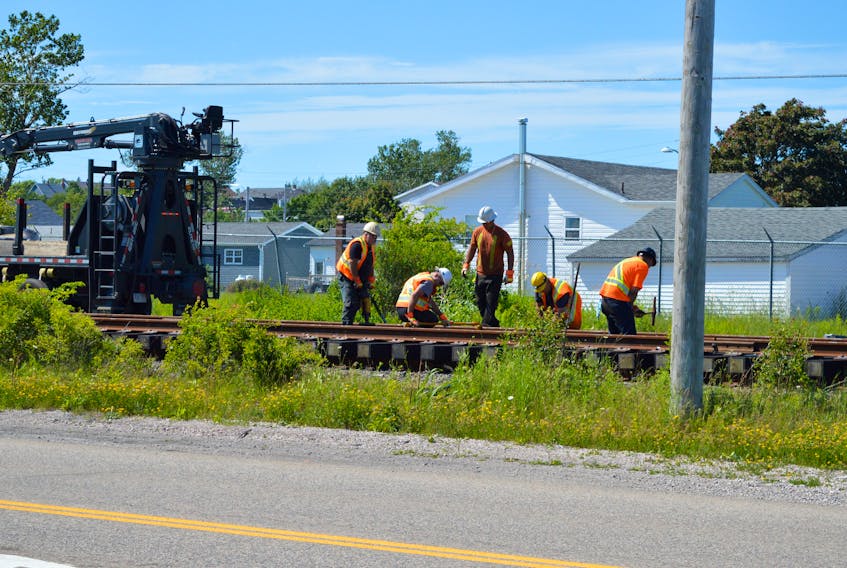Officials with Savage CANAC Corp., are shown working on the railway tracks near the intersection of Lingan Road and Spar Road earlier this week. Two at-grade crossing upgrades are scheduled for next week on the 25-kilometre railway, which connects the Sydney International Coal Pier and Lingan Generating Station. Motorists can expect delays Wednesday and Thursday on Lingan Road near Mary Joe Lane, and at the intersection of Lingan and Spar roads. JEREMY FRASER/CAPE BRETON POST
