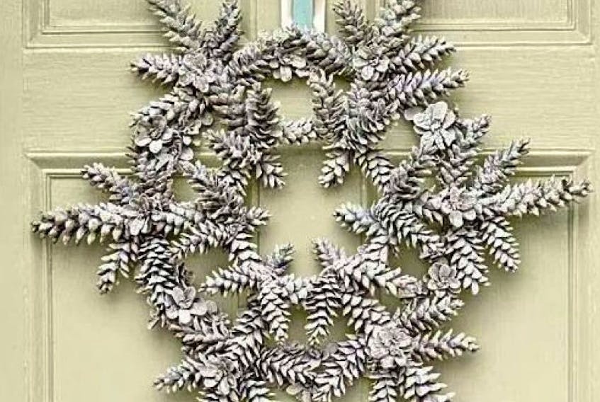 <p>Pine cones arranged in the shape of a snowflake make a unique wreath.</p>