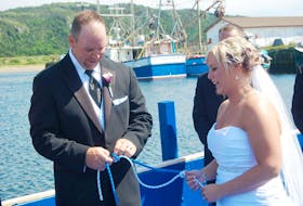 Ben Hickey (left) and Tracy LaCosta were married aboard the long liner she fishes from on Saturday afternoon. The boat was moored at Little Port Harmon and as part of the ceremony the two tied a fisherman’s knot.