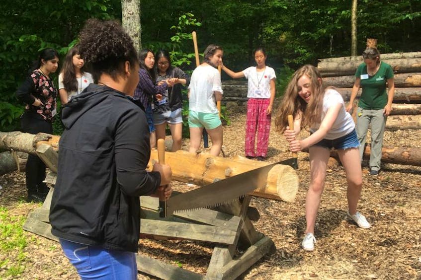 During her youth leadership exchange trip to the United States, Corner Brook’s Caleigh Edwards engaged in team-building activities, including traditional cross-cut sawing, an original industry in the development of the Adirondacks area of New York, during her group's visit to The Adirondack Experience: The Museum at Blue Mountain.