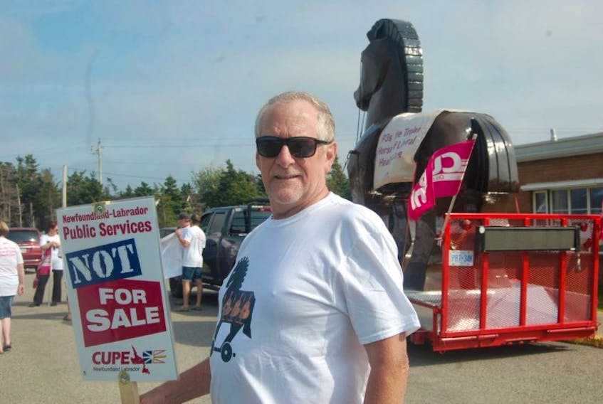 Eric Legge, a member of CUPE Local 4935 at the Bay St. George Long Care Centre in Stephenville Crossing, poses for a photo in front of the CUPE Trojan Horse that’s being compared by his union to P3s.