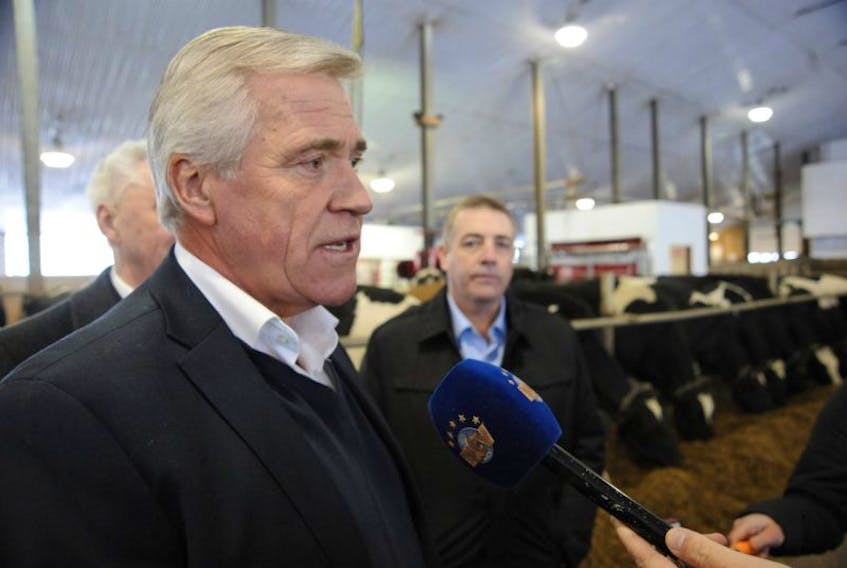 Premier Dwight Ball speaks with the media Thursday morning after announcing the province is making 64,000 more hectares of Crown land available for agriculture development. On the right is Fisheries, Forestry and Agrifoods Minister Steve Crocker.